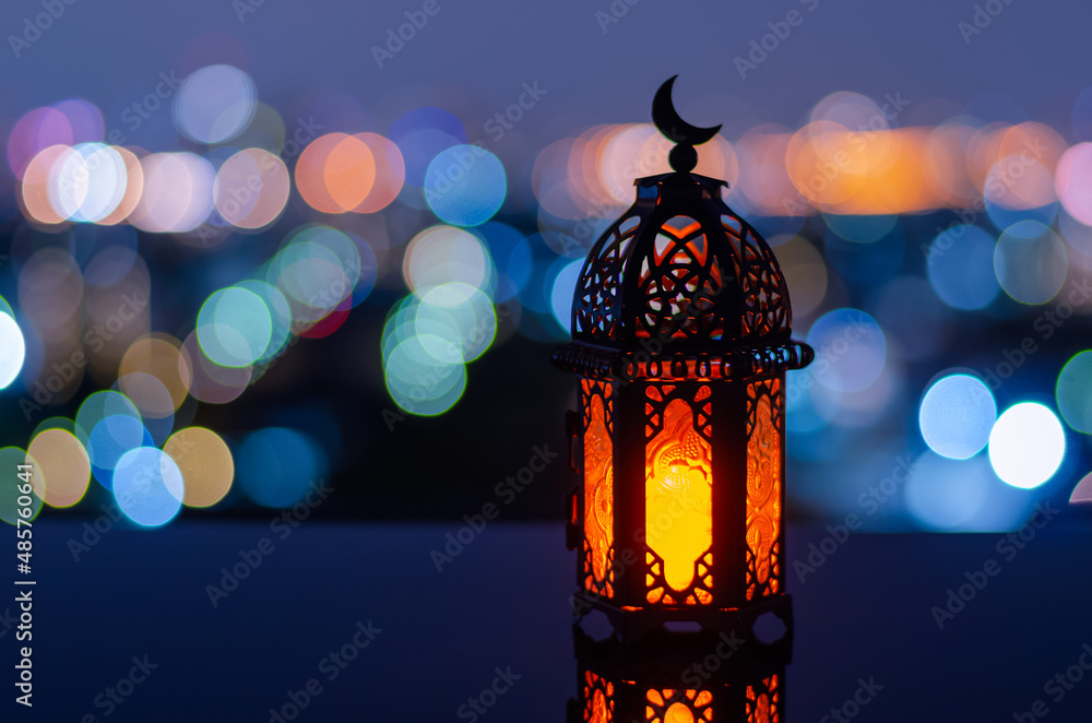 Wall mural selective focus of lantern that have moon symbol on top with city bokeh light background for the mus