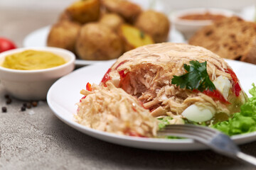 Delicious chicken aspic on a plate on concrete table