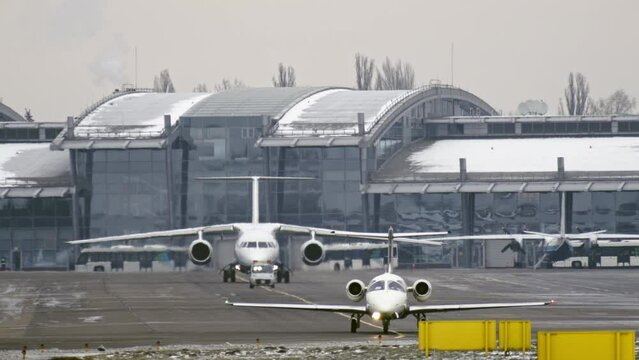 A small private plane goes to the runway and behind him in the queue plane for departure Slow motion video