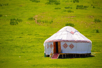 Yurt. National ancient house of the peoples of Kazakhstan and Asian countries. National Housing. Yurts on the background of a green meadow and highlands.