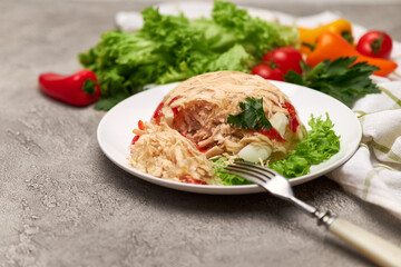 Delicious chicken aspic on a plate on concrete table