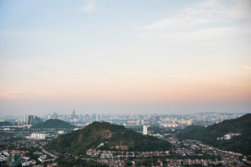 Fototapeta na wymiar Kuala Lumpur skyline seen at sunrise from Bukit Tabur Mountain, Malaysia, Southeast Asia