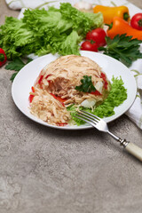 Delicious chicken aspic on a plate on concrete table