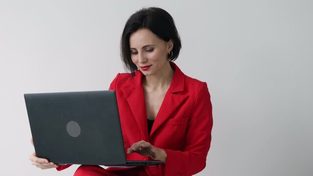 35s nice-looking attractive gorgeous charming cheerful woman using laptop computer on the white wall background texting message technology isolated lifestyle. Mock up copy space. 
