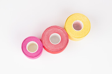 Top view of lifting or kinesio tape rolls isolated on white. Alternative medicine concept