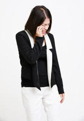 Portrait studio isolated cutout closeup shot of Asian young depressed female businesswoman in formal wears with optical eyeglasses standing holding hands cover cheek closed eyes on white background.