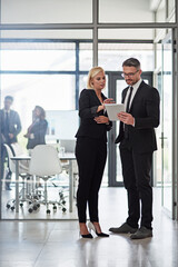 Fototapeta premium Ironing out the details. Shot of corporate businesspeople meeting in the boardroom.