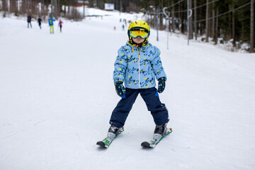 Fototapeta na wymiar Little toddler boy, preschool child, skiing for the first time