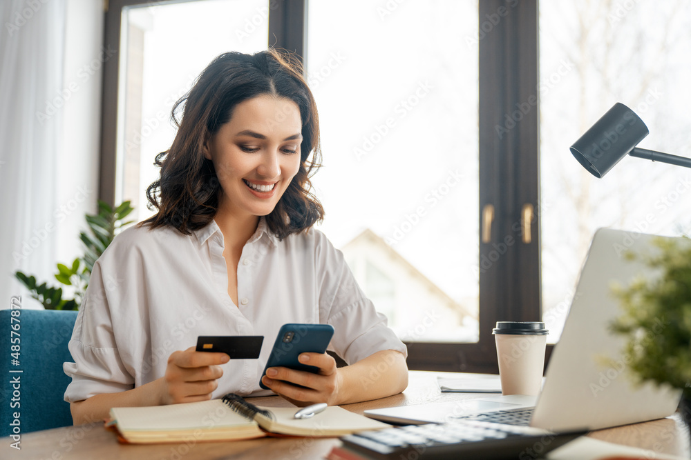 Wall mural woman is doing online purchases