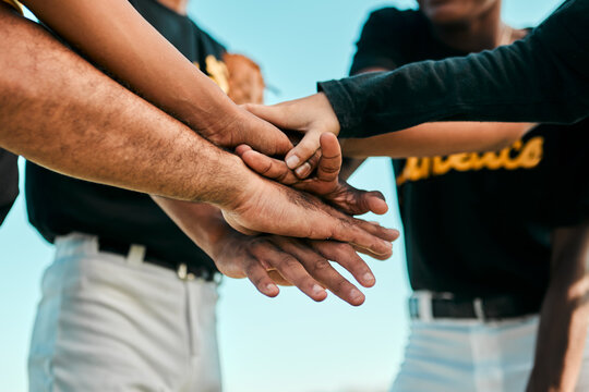 They All Work Together For A Single Purpose. Shot Of A Team Of Young Baseball Players Joining Their Hands Together In A Huddle During A Game.