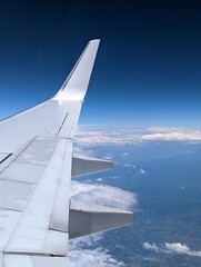 Wing of airplane flying in the sky