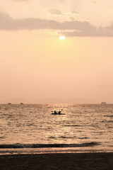 Fototapeta premium Tourist Couple Sea Kayaking at Sunrise at East Railay Beach (Rai Leh), South Thailand, Southeast Asia