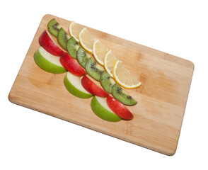 Cut the fruits into slices on a wooden board. green kiwi. yellow lemon. green apple. place for text. on white isolated background. fruit concept