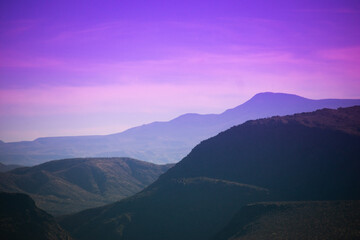Pink sky in desert mountain valley