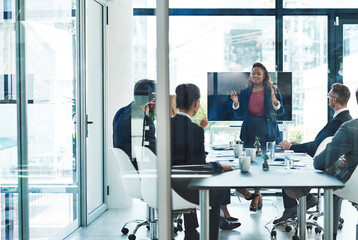 You have to see the big picture. Full length shot of an attractive young businesswoman giving a presentation in the boardroom.
