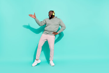 Fototapeta na wymiar Full length body size view of cheerful attractive guy moving dancing hip hop rhythm pop isolated over bright teal turquoise color background