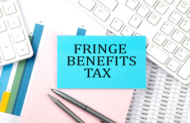 FRINGE BENEFITS TAX text on blue sticker on chart with calculator and keyboard,Business concept
