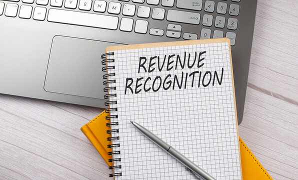REVENUE RECOGNITION text written on a notebook on the laptop