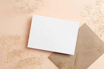 Invitation or greeting card mockup with envelope and dry gypsophila flowers