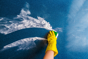 Cleaning concept - hand cleaning glass window pane with detergent and rubber aluminum wiper