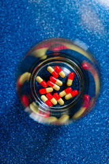 Pills and glass of water - Lifestyle. Vertical shape, copy space.