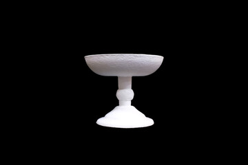 white gypsum vase isolated on a black background