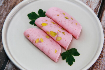 round pieces of meat sausage on a ceramic plate