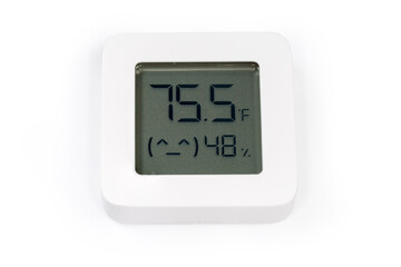 Digital indoor mini thermometer with hygrometer on a white surface - obrazy, fototapety, plakaty