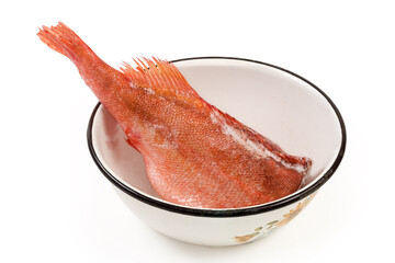 Uncooked frozen headless redfish carcass in the big kitchen bowl