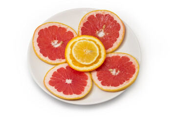 Fototapeta na wymiar Round slices of the various citrus on a white dish