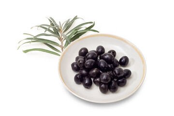 Canned black olives on a saucer against the olive branch