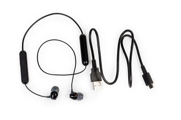 Wireless in-ear earphones and charging cable on white background