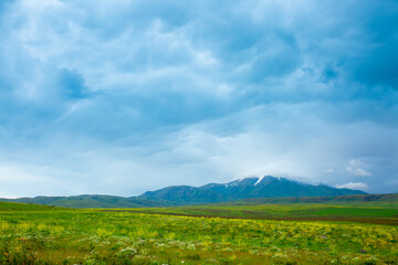 Panoramic view of the mountains in the distance, blue storm clouds over the mountains, cyclone, storm warning. Beautiful nature landscape. The freshness of the mountain air.