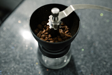 coffee beans, the coffee beans in the grinder are waiting to be ground. Selective focus, noise effect.