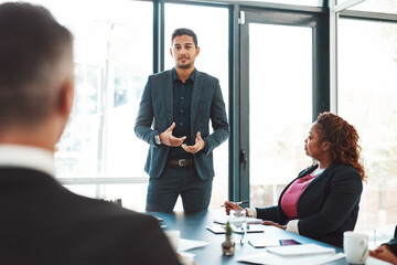 I know youre with me. Cropped shot of a handsome young businessman giving a presentation in the boardroom.