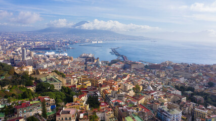 Obraz premium Aerial view of the city of Naples and the harbour on a sunny day. The volcano Vesuvius in the background.