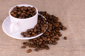 Lots of coffee beans in a cup. Copy space.