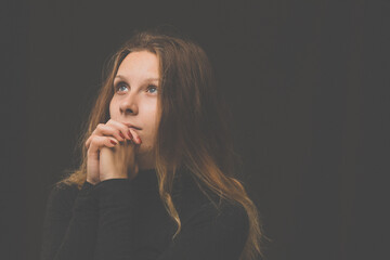 Young woman praying  to God. Christian life crisis prayer to god.