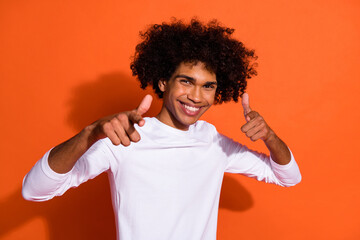 Photo of pretty cool guy dressed white shirt pointing two fingers you isolated orange color background