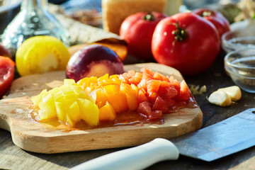 Sliced tomatoes, red and yellow variety. Cooking at home or in a restaurant. Organic food products.