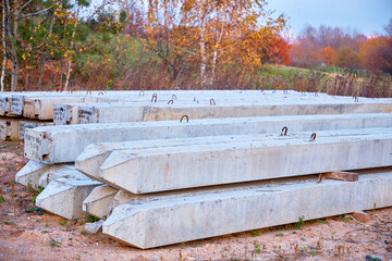 A pile of large and sturdy new concrete pillars or a cement pillar used to build the foundation of a house