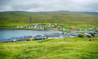 Cloudy day above the beautiful village of Sandavagur. Island of Vagar, Faroe Islands, Denmark.