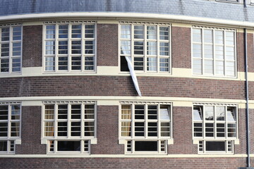 School of Amsterdam Style Building Exterior Detail with White Curtain Hanging from a Window, Netherlands