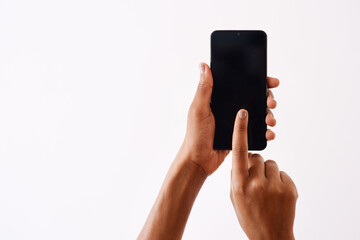A touch can bring just about anything to your doorstep. Studio shot of an unrecognizable woman holding a cellphone against a white background.