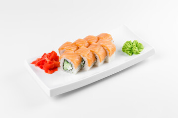 Sushi roll "Philadelphia" with fish. Wasabi and ginger. White plate and background.
