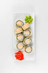 Japanese tempura hot sushi roll on white plate and background. Sushi pieces with cream cheese, wrapped in rice.