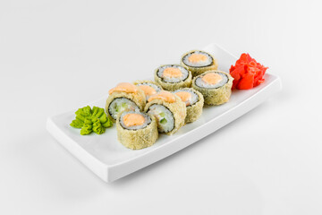 Japanese tempura hot sushi roll on white plate and background. Sushi pieces with cream cheese, wrapped in rice.