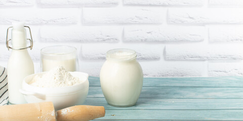 Baking ingredients - eggs, flour, milk on a blue wood background. with place for text