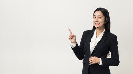 Happy young asian business woman call centre pointing finger to blank space. Welcome female...