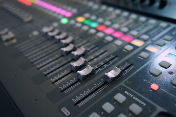 Professional audio mixing console. ​Mixer. Pro audio mixing board faders and knobs. Static shot of multi-track music recording equipment faders and sliders. 